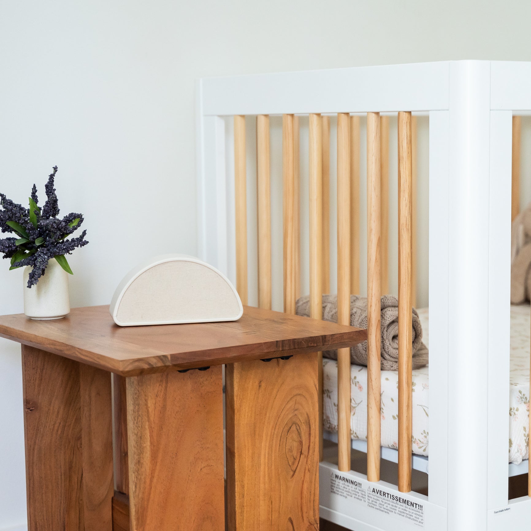 Shushiie placed next to a crib