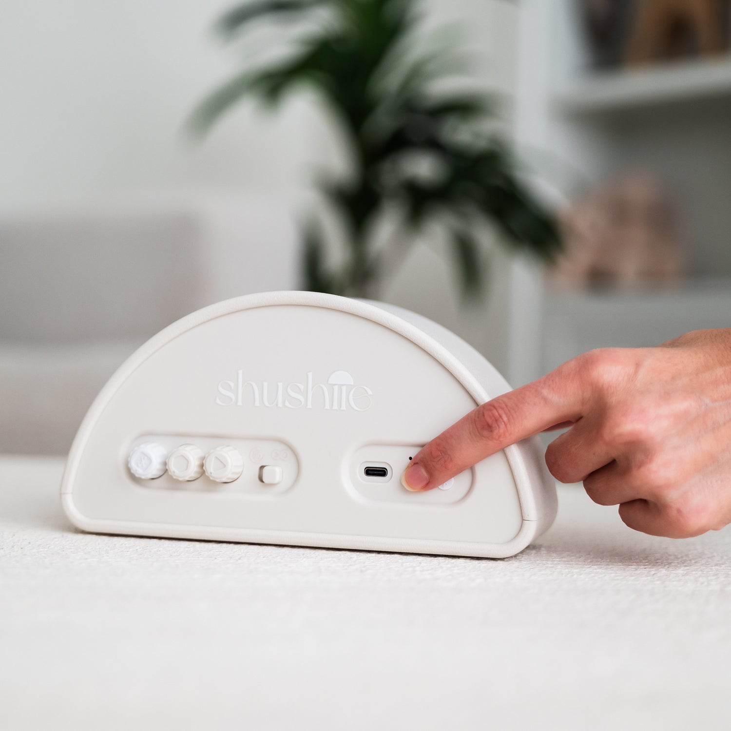 Woman turning Shushiie on by pressing power button